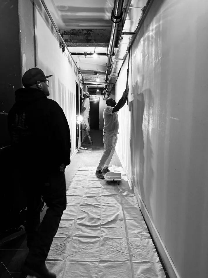 Contractor inspecting a protected corridor during renovation