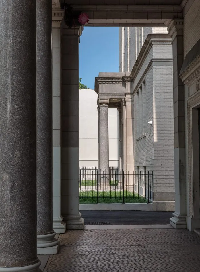 Colonnaded passage opening to a neoclassical building
