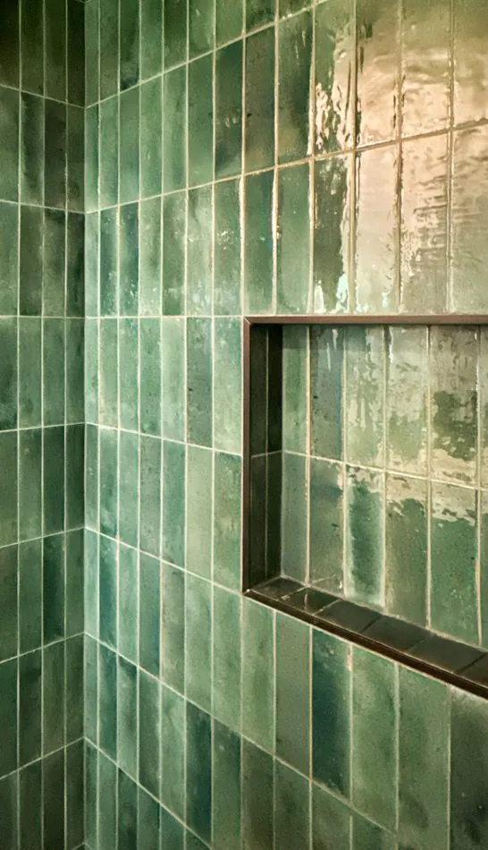 Green glazed tile wall with a recessed niche