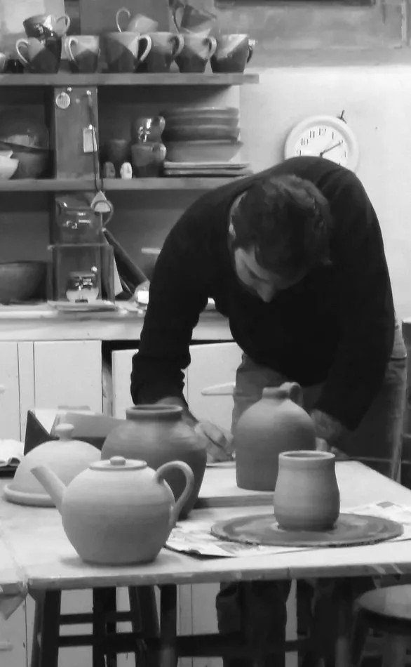 Potter shaping a teapot at a ceramics studio