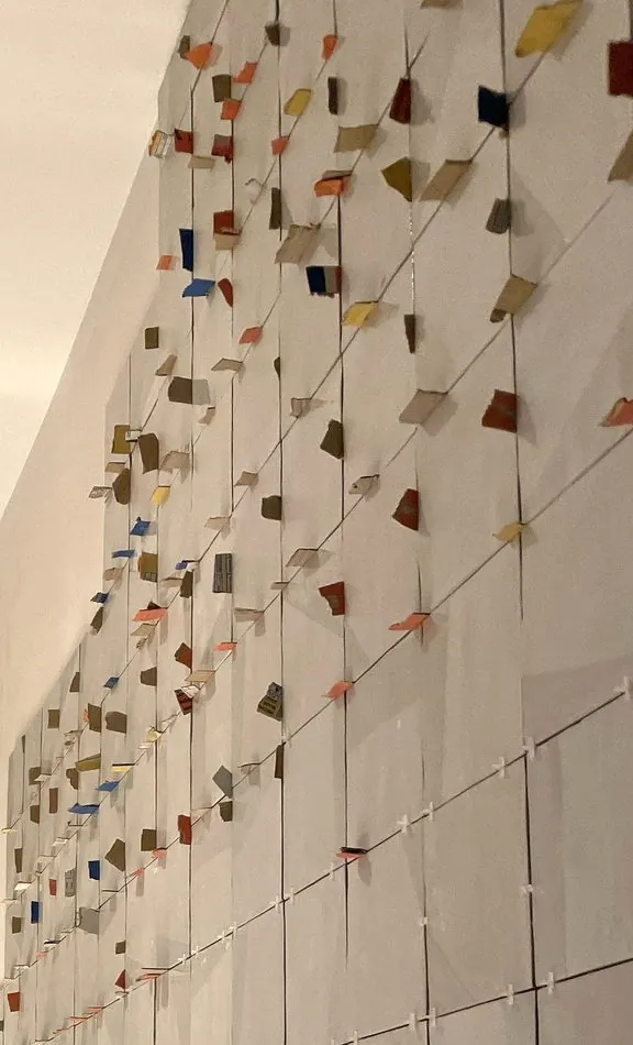 Hand-placed colored tile pattern on a wall installation
